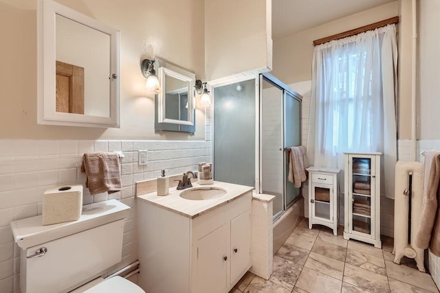 442 Summit Ave Unit 6, Saint Paul, MN 55102 - bathroom featuring vanity, tile walls, and bath / shower combo with glass door