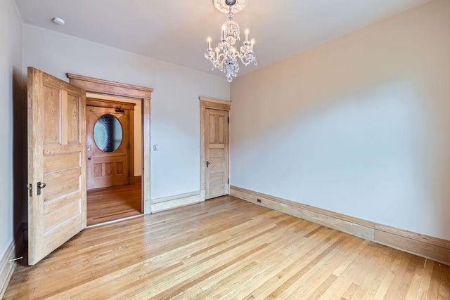 442 Summit Ave Unit 6, Saint Paul, MN 55102 - unfurnished room with a chandelier, light wood-type flooring, and a smoke detector