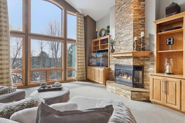 carpeted living room featuring high vaulted ceiling, a wealth of natural light, and a fireplace