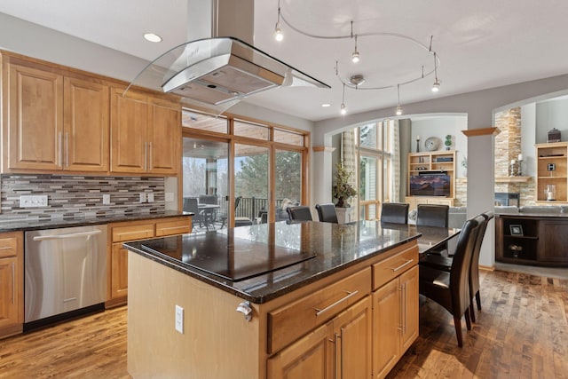 kitchen featuring a kitchen island, dishwasher, dark stone countertops, island exhaust hood, and light hardwood / wood-style flooring