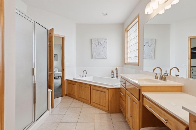 bathroom with vanity, shower with separate bathtub, and tile patterned floors