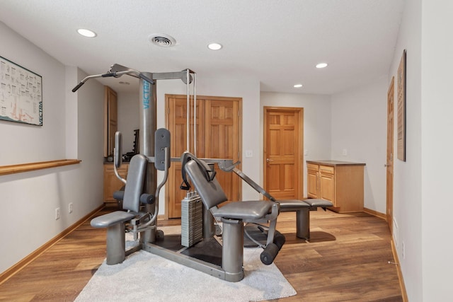 workout room featuring light hardwood / wood-style floors