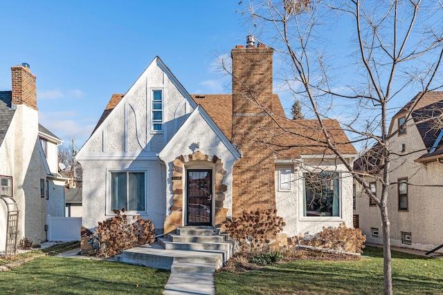 tudor home featuring a front yard