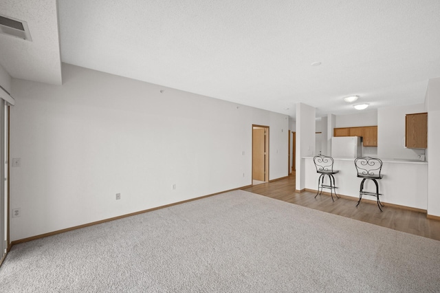 unfurnished living room featuring carpet floors