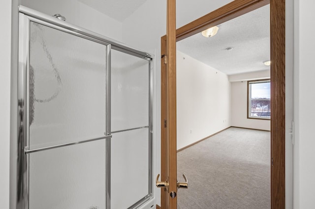 bathroom featuring a textured ceiling and an enclosed shower