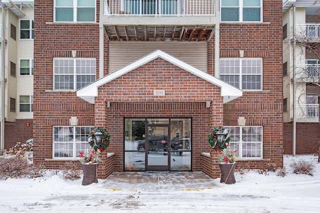 view of snow covered property entrance