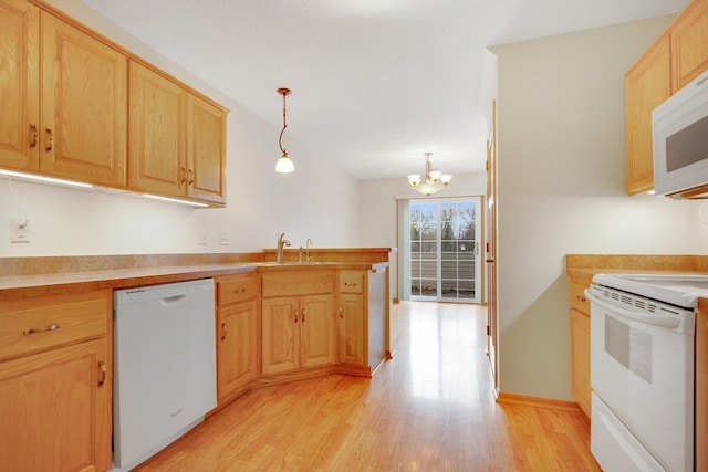 kitchen with an inviting chandelier, light brown cabinets, a sink, white appliances, and light wood-style flooring