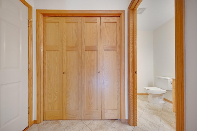 hallway with visible vents and baseboards