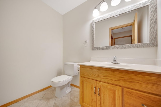 half bathroom featuring vanity, baseboards, tile patterned floors, toilet, and lofted ceiling