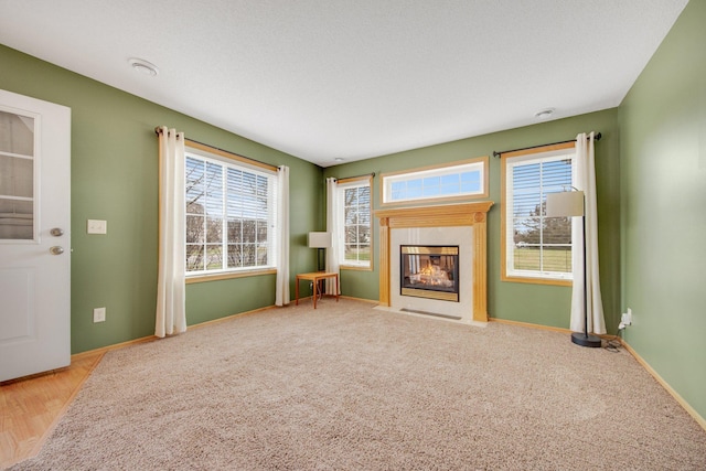 unfurnished living room with baseboards and a multi sided fireplace