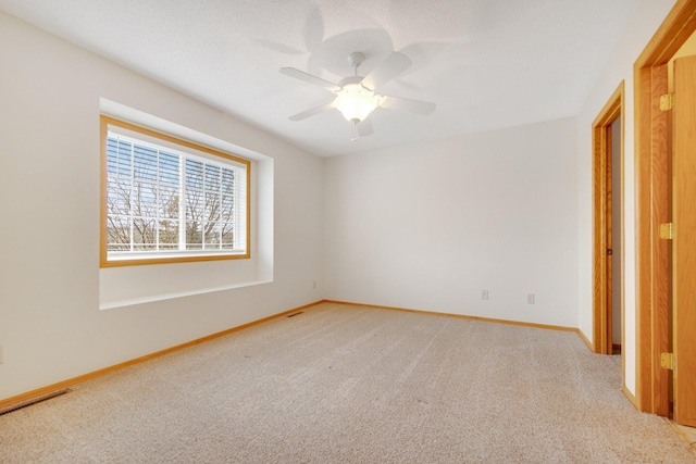 unfurnished bedroom featuring light carpet, ceiling fan, baseboards, and visible vents