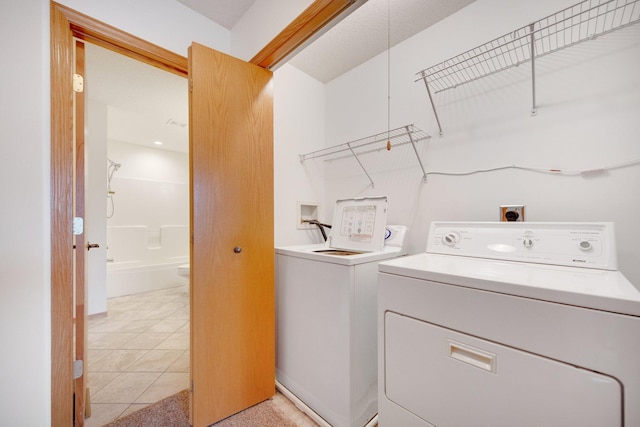 laundry area with washing machine and clothes dryer and laundry area