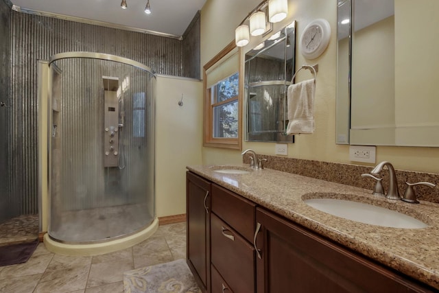 full bath with double vanity, a shower stall, a sink, and tile patterned floors