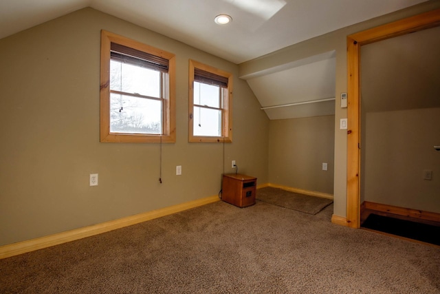 N1865 980th St, Rock Creek Twp, WI 54701 - additional living space with vaulted ceiling, carpet floors, and baseboards