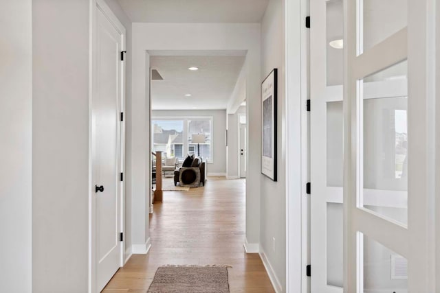 hall with light hardwood / wood-style flooring