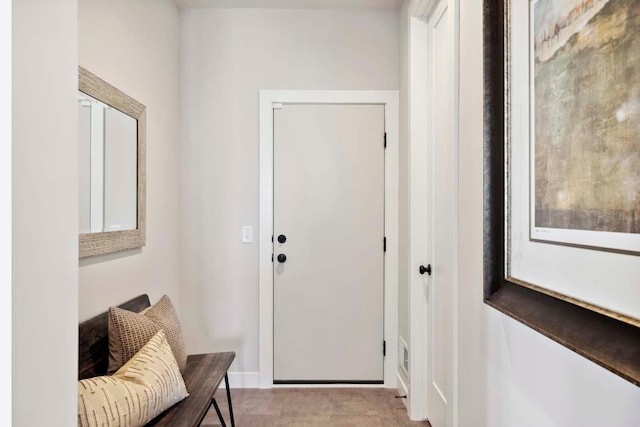 doorway featuring light tile patterned flooring