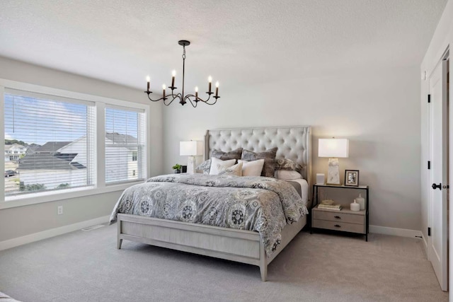 bedroom featuring a chandelier and light colored carpet