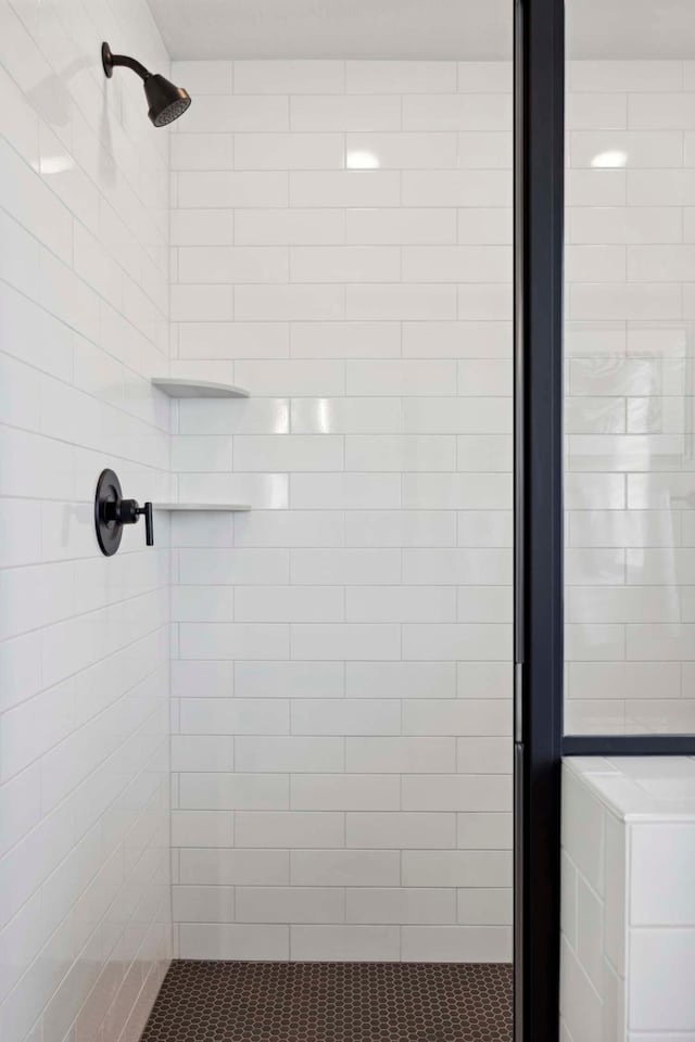 bathroom with tiled shower