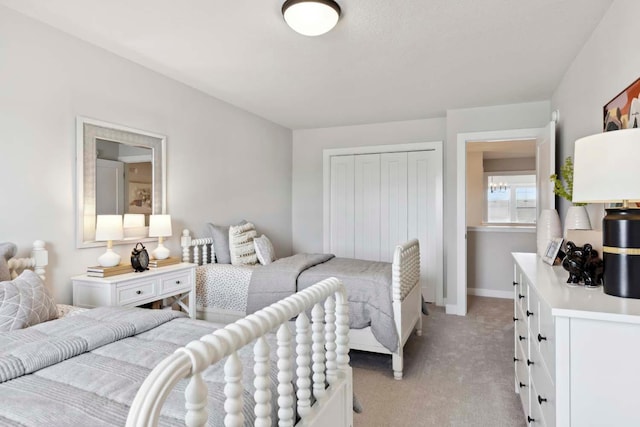 bedroom featuring light carpet and a closet