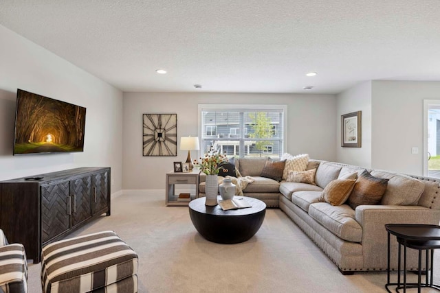 carpeted living room with a textured ceiling