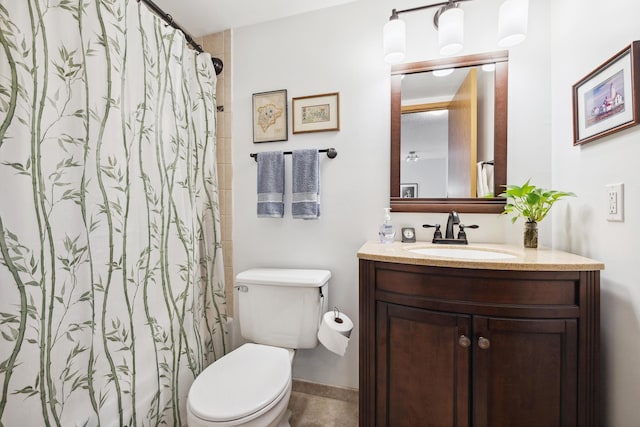 bathroom featuring walk in shower, vanity, and toilet