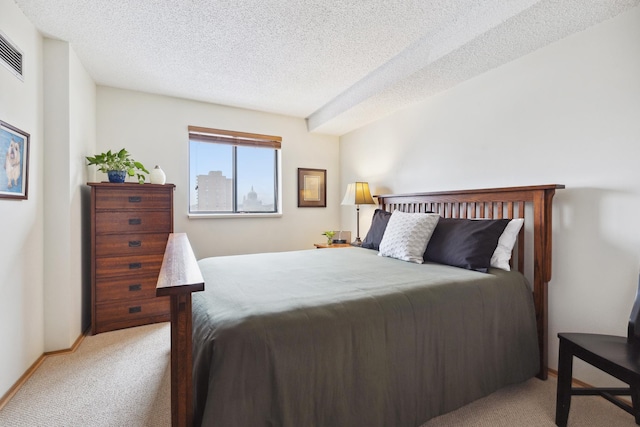 carpeted bedroom featuring a textured ceiling