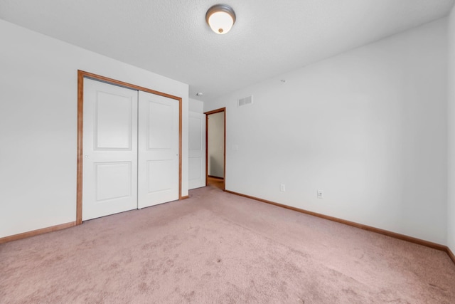 unfurnished bedroom with carpet floors and a closet