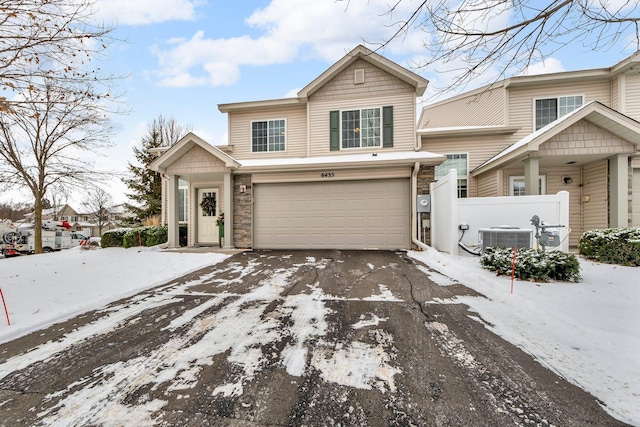 view of front of home with central air condition unit and a garage