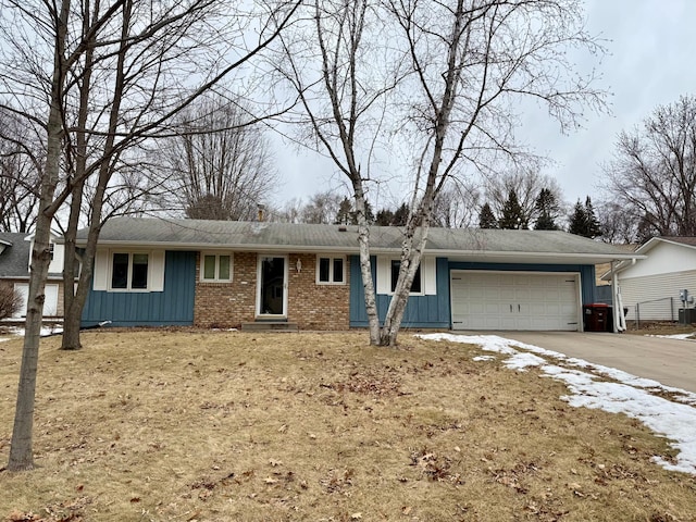 ranch-style house featuring a garage and central AC unit