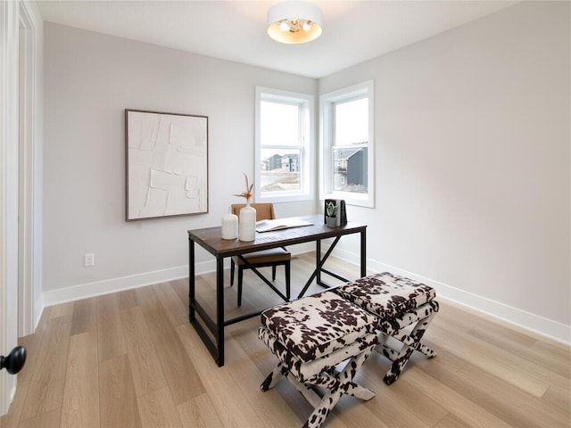 office with baseboards and light wood finished floors