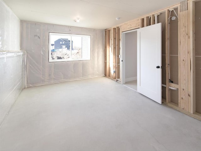 unfurnished room with concrete floors