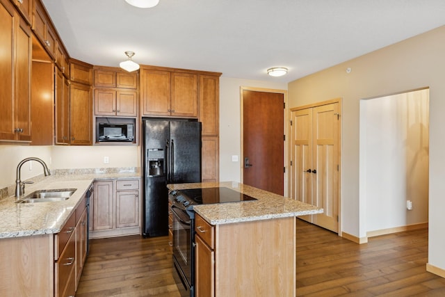 kitchen featuring a kitchen island, dark wood-type flooring, a sink, and black appliances