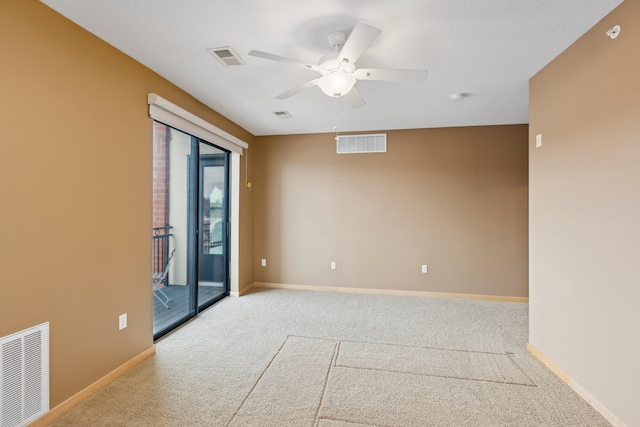 empty room with carpet floors, visible vents, and baseboards