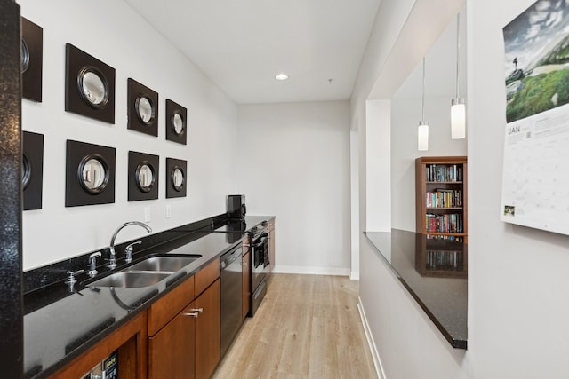 kitchen featuring dark stone counters, a sink, light wood-style floors, dishwasher, and brown cabinetry