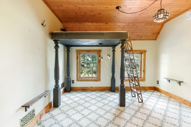 interior space with vaulted ceiling, ornamental molding, and wooden ceiling