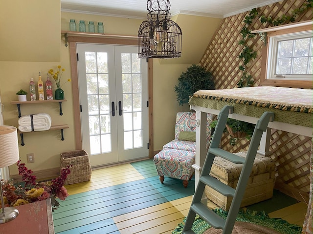 doorway featuring ornamental molding, wood-type flooring, a healthy amount of sunlight, and french doors