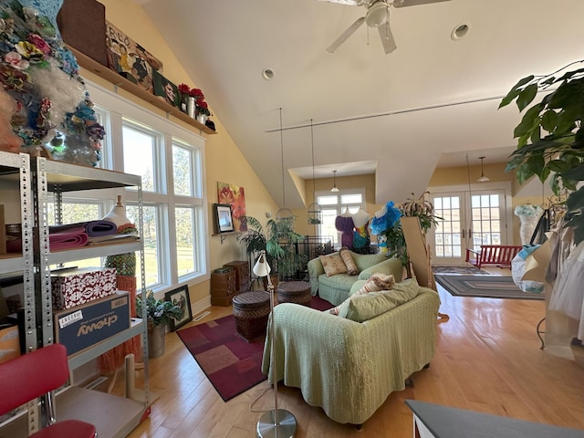 living room with ceiling fan, high vaulted ceiling, and light hardwood / wood-style floors