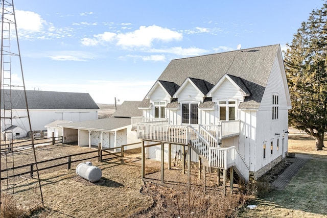 rear view of property featuring a wooden deck