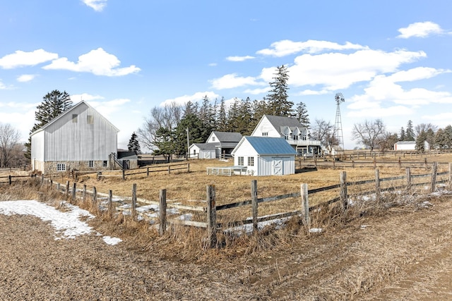 view of yard with an outbuilding and a rural view