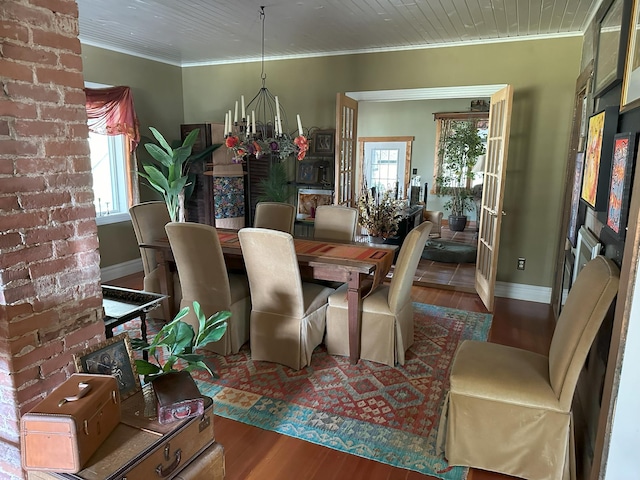 dining area featuring hardwood / wood-style flooring, ornamental molding, french doors, and a chandelier