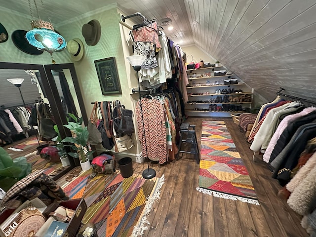 walk in closet with lofted ceiling and dark hardwood / wood-style flooring