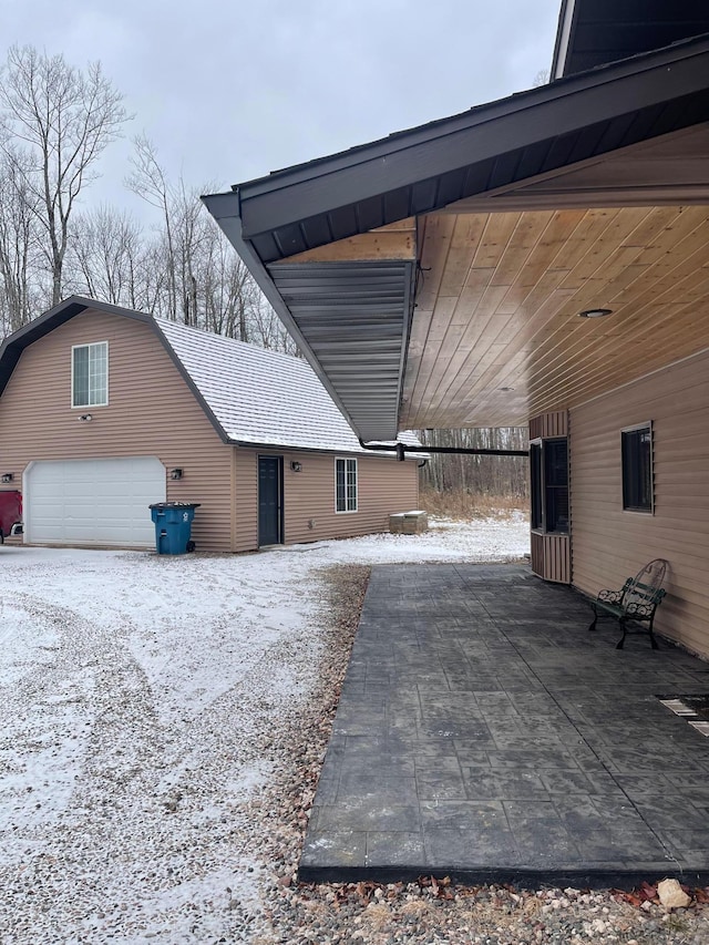 snow covered property featuring a garage