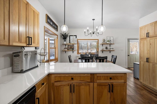 kitchen featuring decorative light fixtures, plenty of natural light, kitchen peninsula, and a notable chandelier