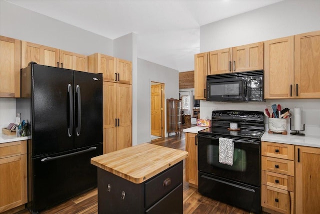 kitchen featuring light brown cabinetry, dark hardwood / wood-style floors, and black appliances