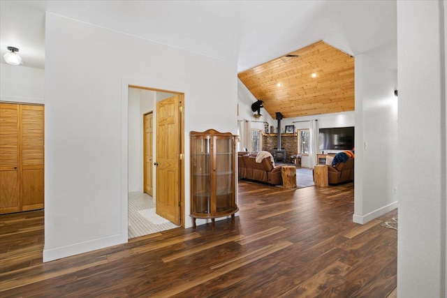 hall featuring dark wood-type flooring, wooden ceiling, and vaulted ceiling