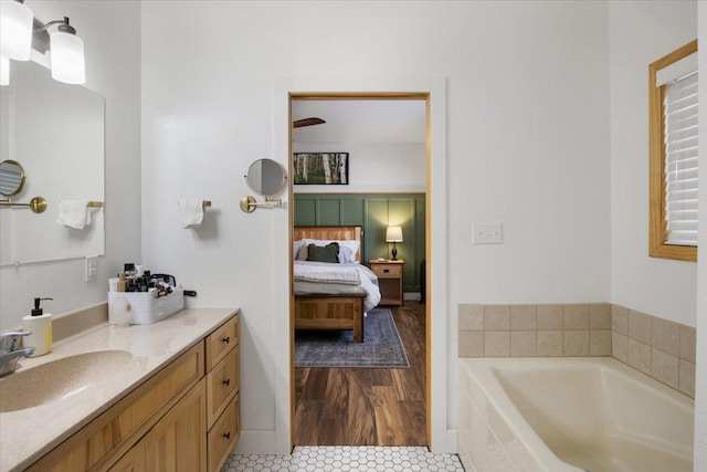 bathroom with vanity, tile patterned floors, and a relaxing tiled tub