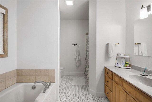 bathroom featuring a tub to relax in, toilet, vanity, and tile patterned flooring