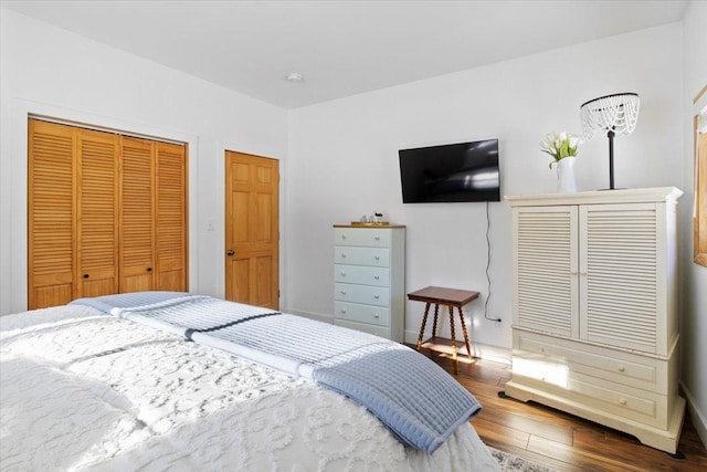 bedroom with a closet and dark hardwood / wood-style flooring