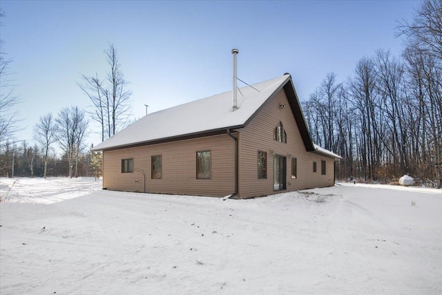 view of snow covered rear of property