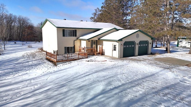 view of front facade with a garage and a wooden deck
